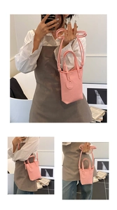 Pink lychee grain mini bucket bag showing handheld and crossbody styling for women