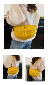 Detail view of yellow nylon crescent bag featuring adjustable strap and OK logo