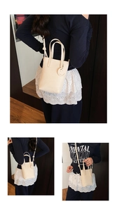 Detail of cream white lychee leather mini tote bag with smile charm on dark wood background