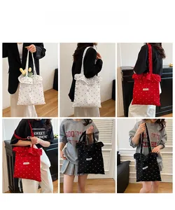 Detailed views of polka dot ruffle tote bags in white red and black colors