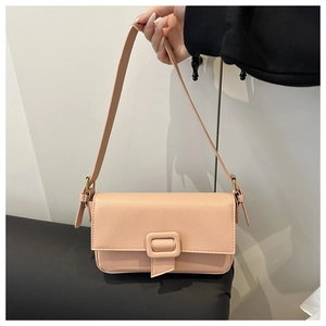 Detail of nude pink faux leather shoulder bag with pebbled texture and square buckle