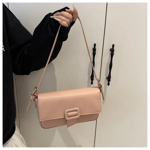 Close-up of pink lychee pattern faux leather baguette bag with magnetic buckle closure