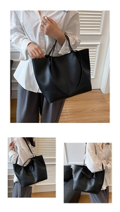 Close-up of minimalist black tote bag with long straps for shoulder or hand carry