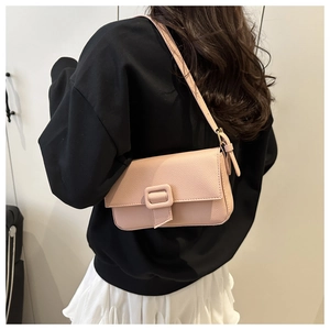 Pink lychee texture crossbody bag shown from back view on model for style and size reference