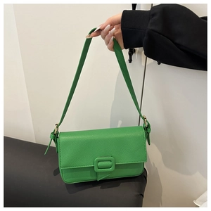 Detail of green litchi grain faux leather shoulder bag with adjustable strap and buckle