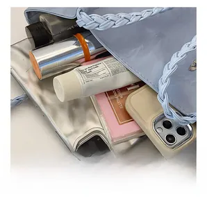 Detail view of large capacity light blue tote interior showing tablet and daily essentials