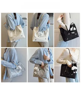 Detail view of butterfly tote bag options in white, black and silver with cloud pendant