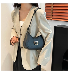 Chic black half-moon hobo bag with gold D-ring buckle worn with a beige blazer