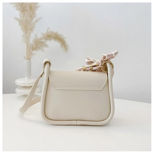 Detail of cream white leather crossbody bag with striped silk scarf and gold hardware