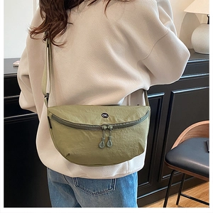 Detail of olive green nylon crescent bag with adjustable strap and OK emblem
