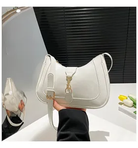 Dettaglio della borsa hobo in pelle bianca con chiusura a pistone in metallo dorato