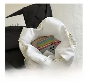 Interior view of white floral canvas tote bag showcasing large capacity for daily items
