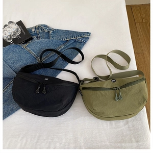 Nylon crescent crossbody bags in black and army green with minimalist ok print