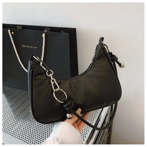 Detail of black crescent hobo bag with unique knot decor and silver metal beads