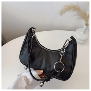 Detail view of black crescent hobo bag with silver metal ring and knotted strap accents