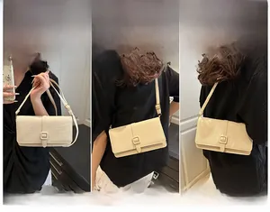 Detail view of the beige square crossbody bag showing handheld, shoulder and crossbody styles
