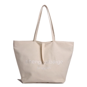 Minimalist beige canvas tote bag with large capacity for daily commute and school