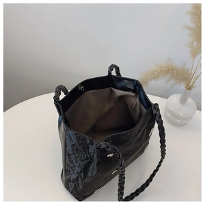 Detail view of large star print tote bag featuring woven handles and spacious interior