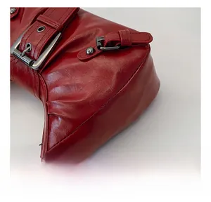 Close-up of high-quality red oil-wax leather texture and precision stitching on bag