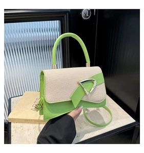 Detail of green leather and beige woven fabric stitching with a gold D-shaped buckle