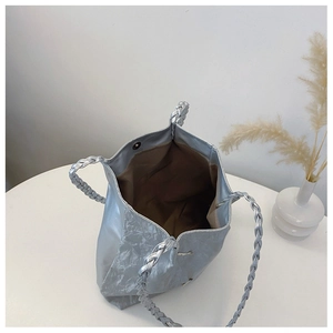 Detailed interior of silver tote bag showing brown lining and magnetic closure