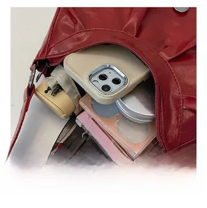 Interior view of red glossy crescent bag showing space for phone and essentials
