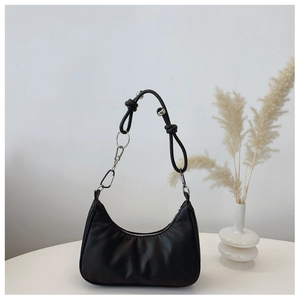 Detail of hobo bag featuring knotted leather strap and silver metal chain hardware