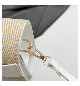 Detail of woven fabric handbag with golden D-ring and lobster clasp hardware