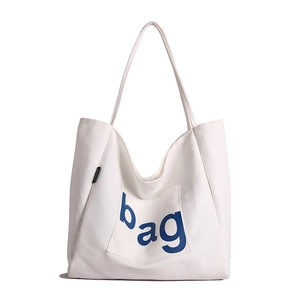 Minimalist white canvas tote bag with blue 'bag' print and black fashion label detail