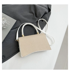 Detail of beige woven flap and white leather hourglass bag with gold handle hardware