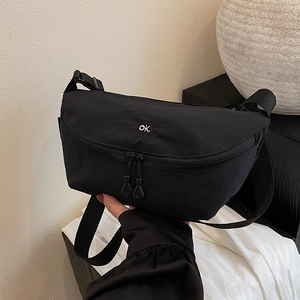 Minimalist black crescent crossbody bag with white ok embroidery and adjustable strap