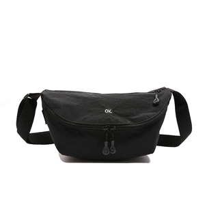 Minimalist black crescent nylon crossbody bag with adjustable strap and logo detail