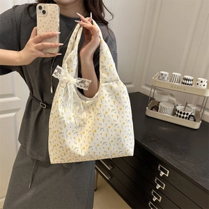Floral canvas tote bag for women with yellow flower print and white lace bow detail