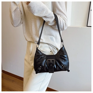 Detail of a vintage black crescent bag with polished silver buckles and adjustable strap