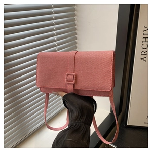 Close-up of pink woven texture crossbody bag with matching shoulder strap for women