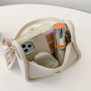 Mini cream leather crossbody bag with striped scarf and interior storage capacity