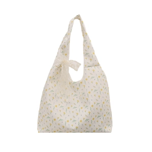 Floral canvas shoulder bag with cream lace bow decoration for a summer casual look