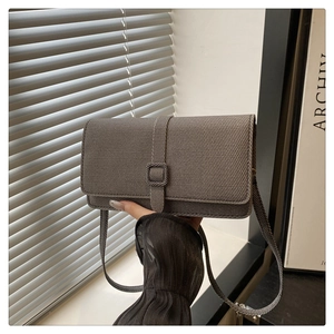 Detailed macro view of grey twill texture shoulder bag with stylish buckle strap