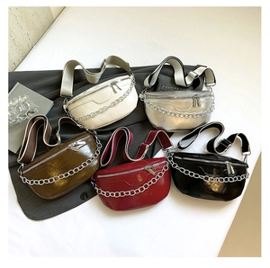 Five assorted glossy saddle bags with chunky silver chains and striped wide canvas straps