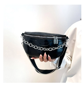 Detail of black PU fanny pack featuring silver chain and monochrome woven strap