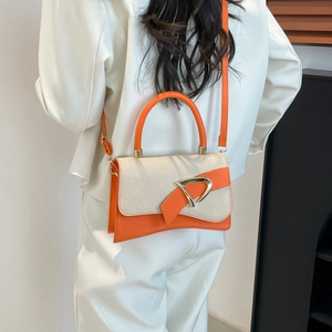 Modern white canvas and orange leather crossbody bag with metal D-buckle and top handle