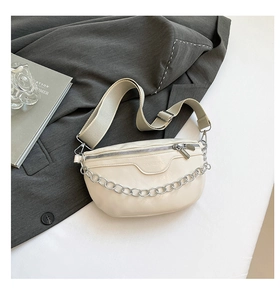 Detail of beige faux leather waist bag with silver chain and FASHION embossed text