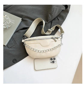 Detail of off-white crescent waist bag featuring fashion embossing and silver chain