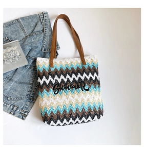 Close-up of woven tote bag with colorful chevron pattern and Summer letter patch