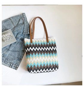 Detailed top view of a colorful zigzag woven tote bag with brown leather straps