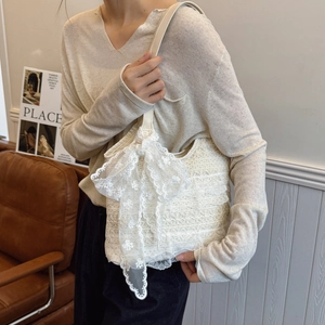 Chic white lace crochet tote bag with a large bow decoration for casual summer use