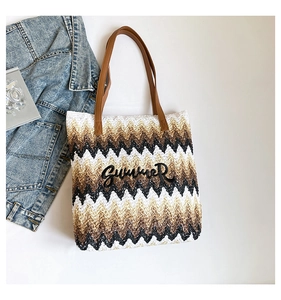 Detailed top view of a woven tote bag featuring zigzag patterns and Summer embroidery