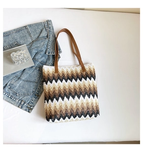 Detailed close-up of woven tote bag with vintage brown and black zigzag straw patterns