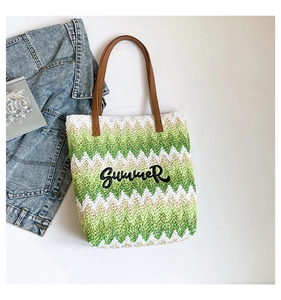 Detail of Summer embroidery on woven beach tote with brown leather handles and waves
