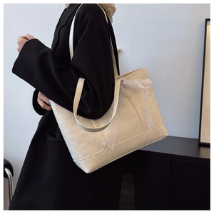 Cream tote bag with embossed bear patterns and delicate lace bow detail